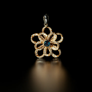 Natural alexandrite flower pendant with diamonds set in 18k rose and white multitone gold